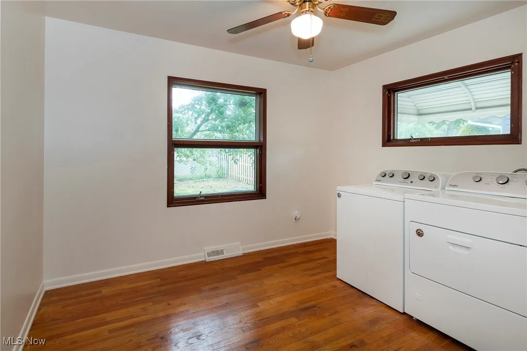 Laundry room with hardwood flooring and washing machine and clothes dryer - could be converted back to a bedroom