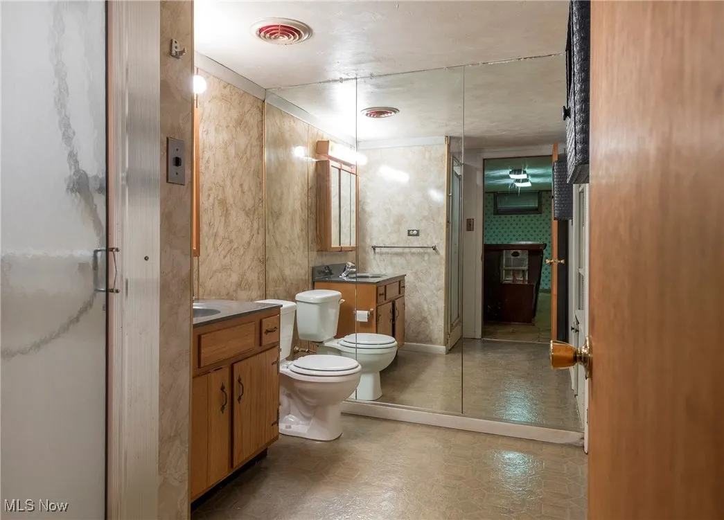 Basement Bathroom featuring vanity and a stall shower