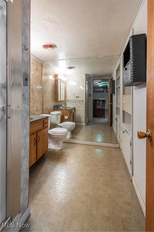 Basement Bathroom featuring vanity and a stall shower
