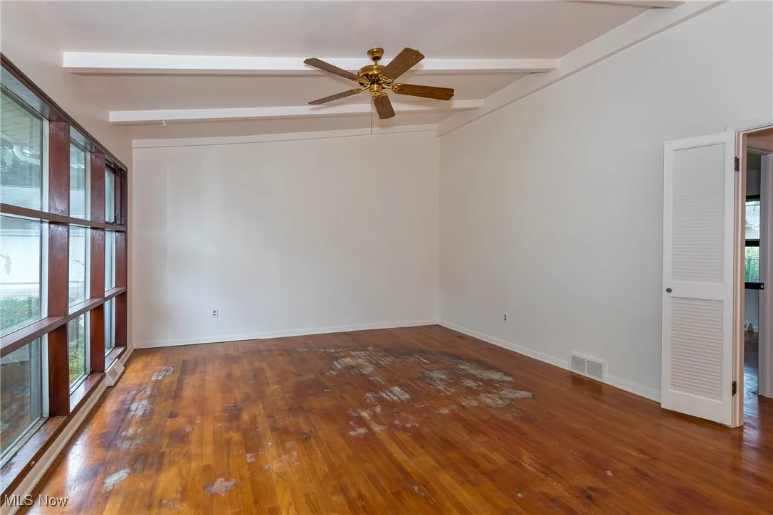 Long view of living room, there are stains on the hardwood floor