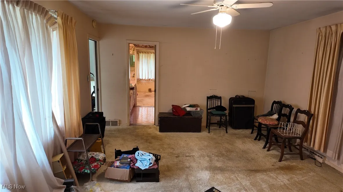 Sitting room with carpet floors and ceiling fan