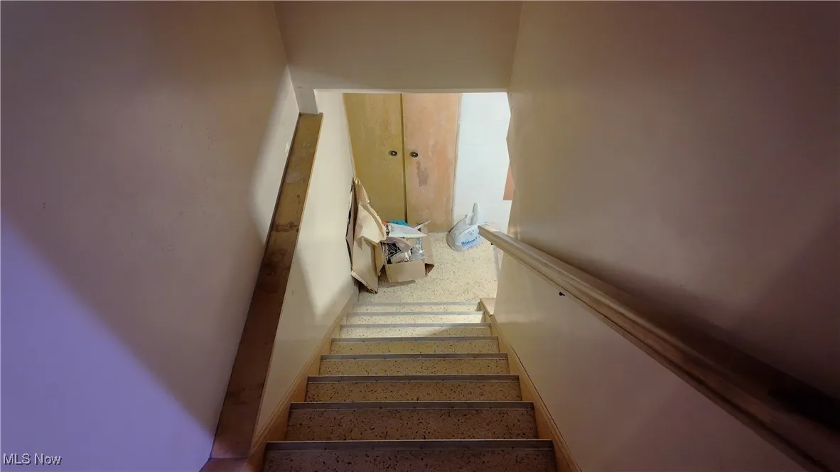 Staircase featuring speckled floor