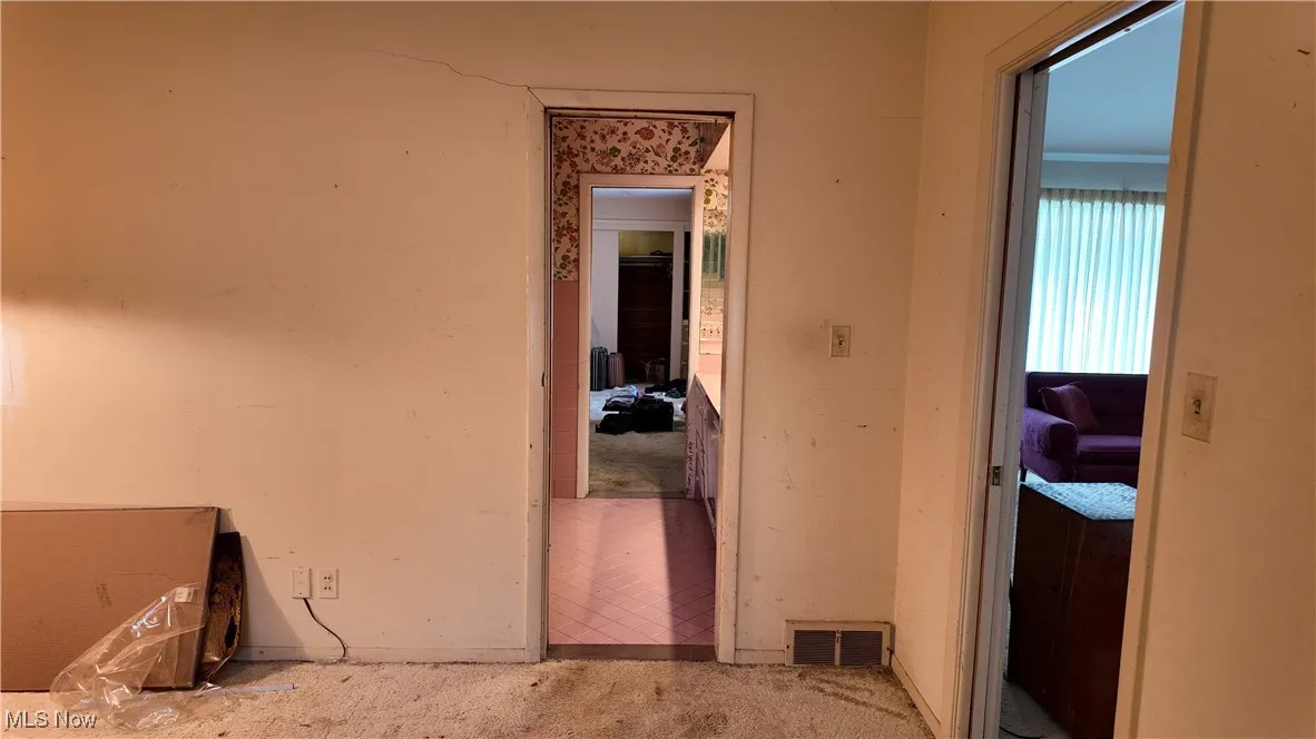 Hallway featuring baseboards