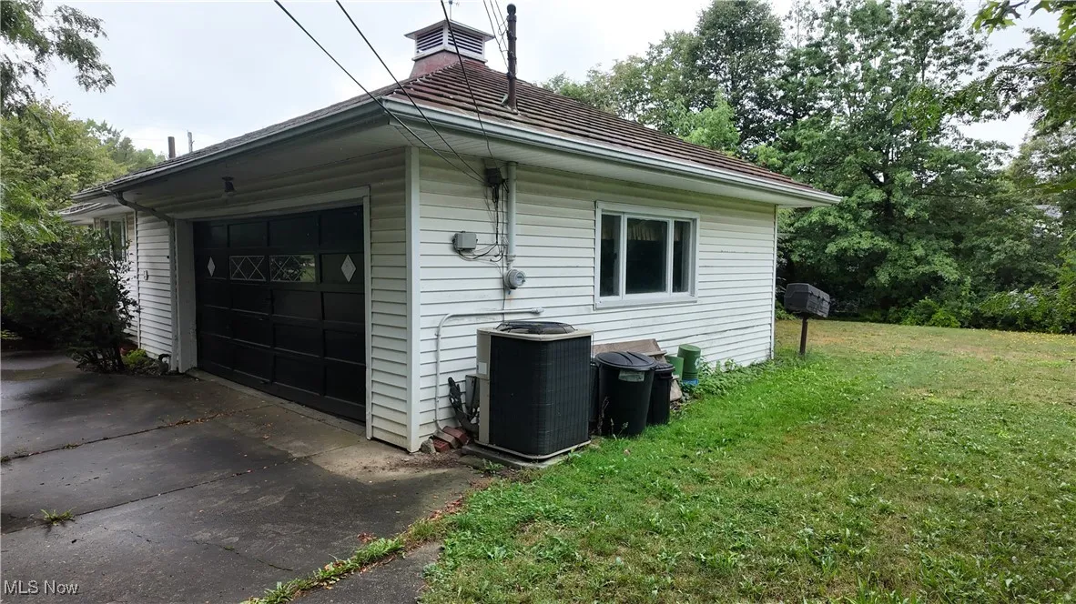 View of attached garage and partial yard