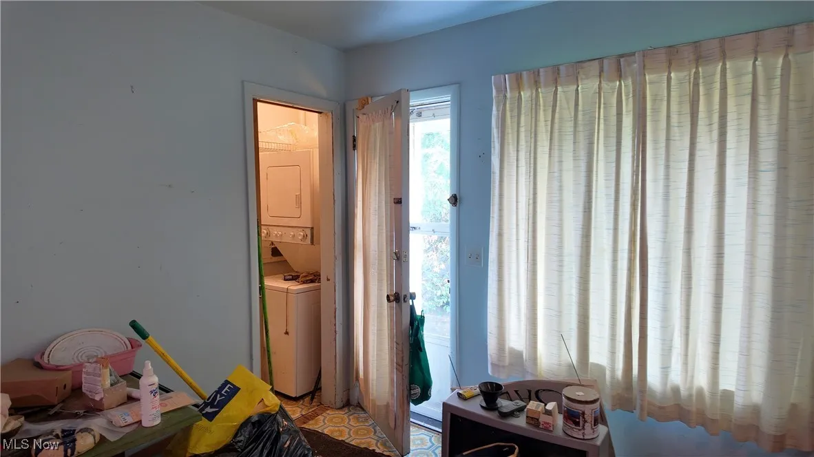 Bedroom featuring stacked washer / dryer