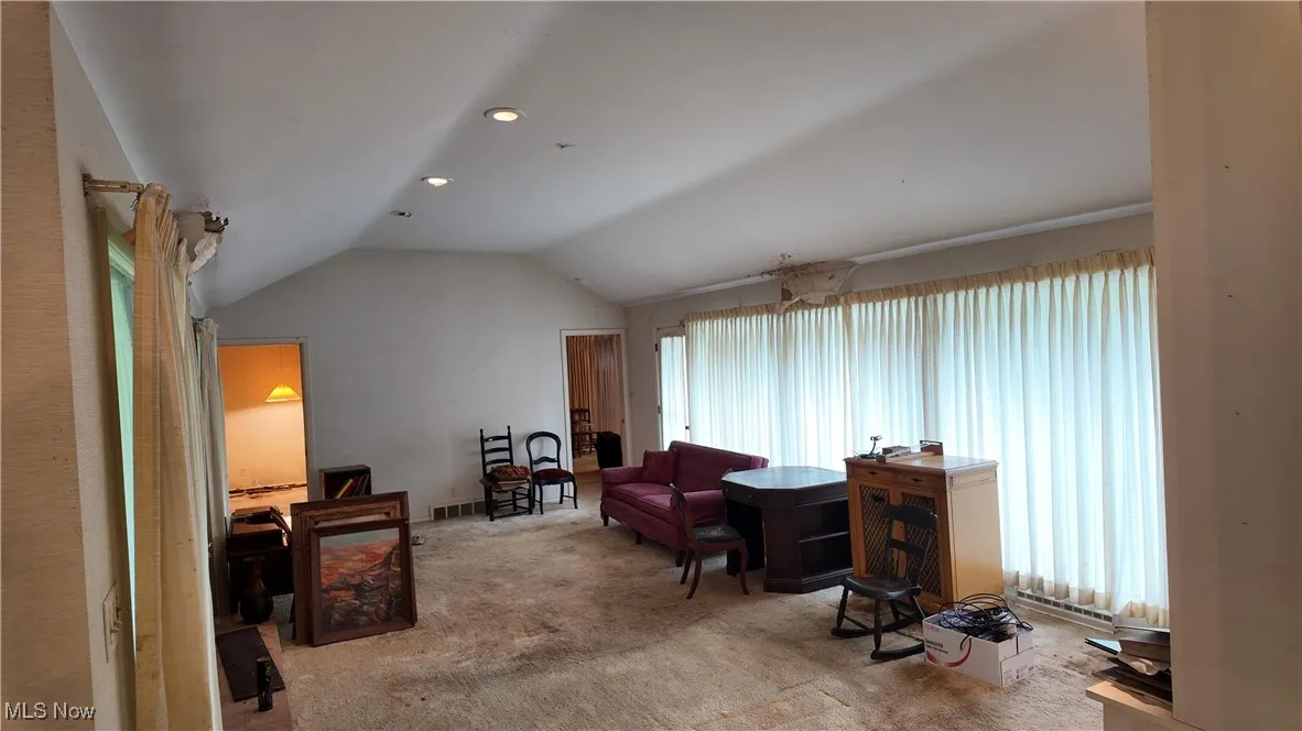 Sitting room with vaulted ceiling, carpet, and recessed lighting
