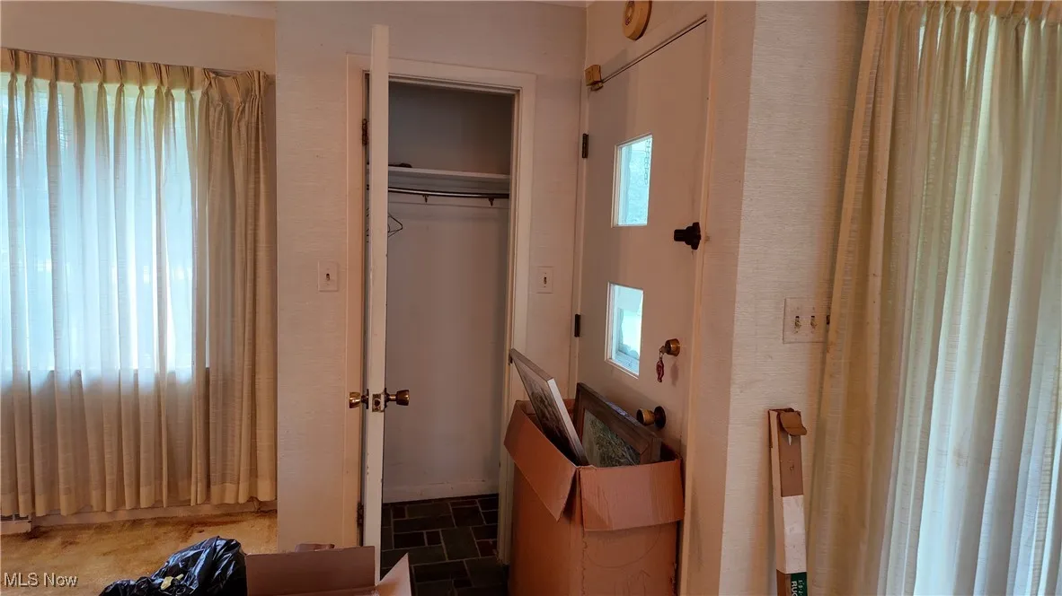 Bedroom featuring multiple windows and a closet