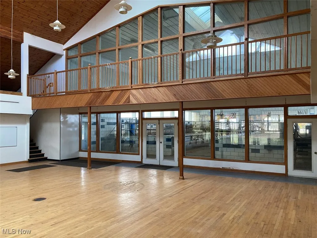 Building lobby with high vaulted ceiling, wood ceiling, and stairs