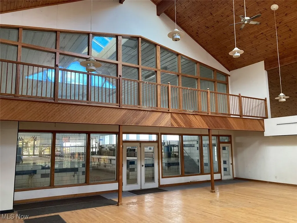Common area featuring high vaulted ceiling and a wood ceiling with exposed beams