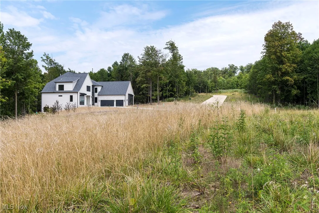 Back of property featuring a view of trees