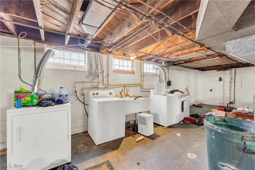 Below grade area featuring separate washer and dryer and a sink