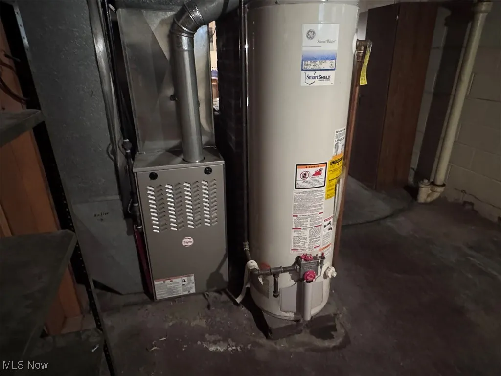 Utility room featuring gas water heater and newer forced hot air furnace.