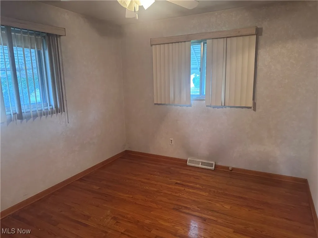 Master Bedroom with hardwwood floors and ceiling fan