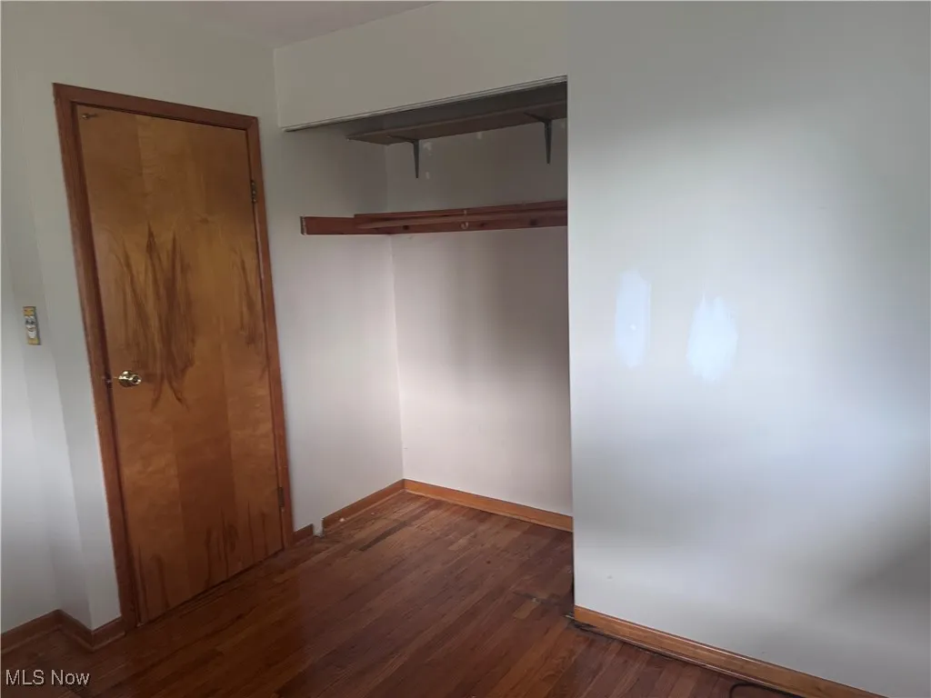 Bedroom 2 with hardwood floors.