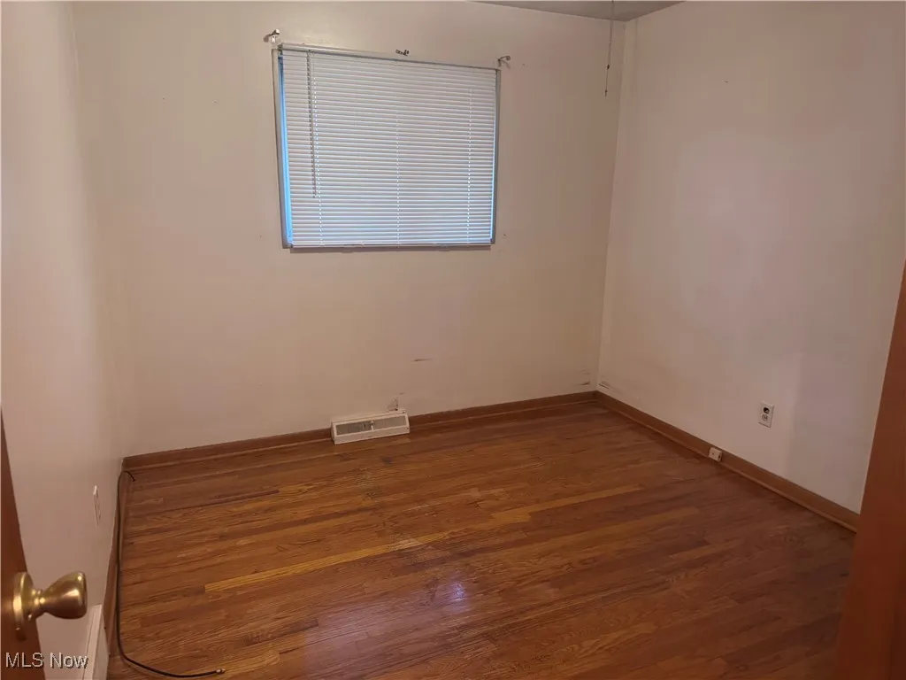 Bedroom 1 with hardwood floors. finished floors and baseboards