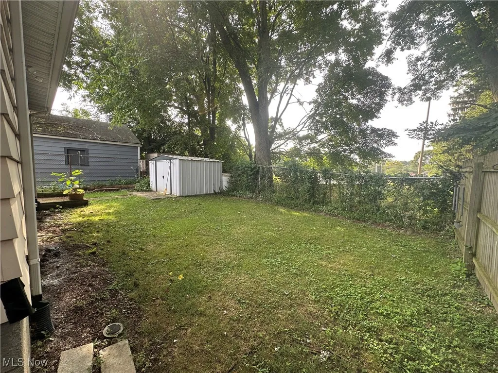 Fenced backyard with a storage unit