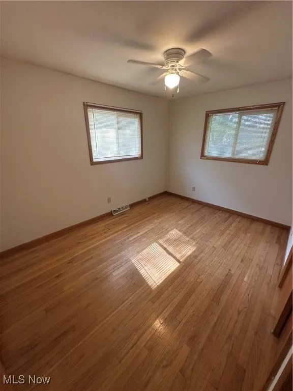 Unfurnished room featuring light wood-type flooring and baseboards