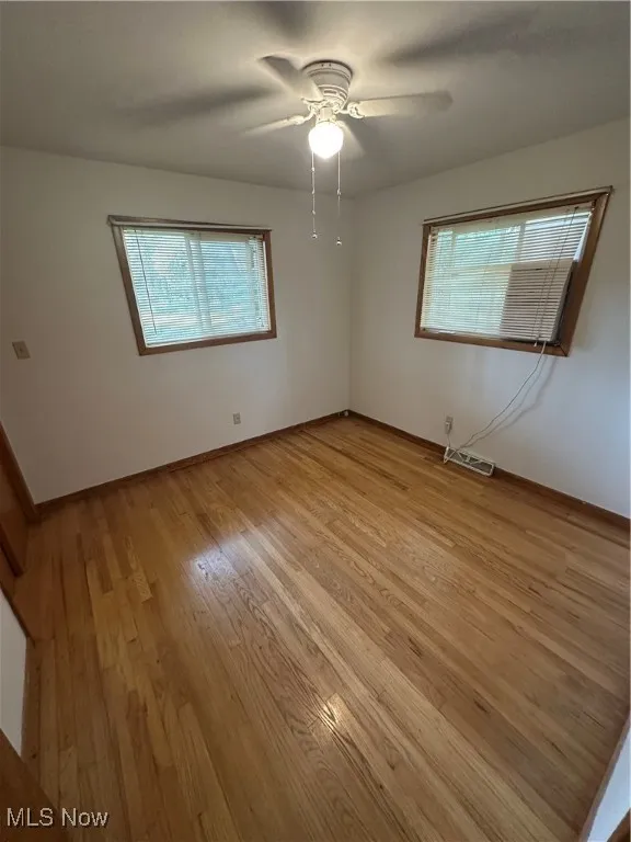 Unfurnished bedroom featuring light wood-style floors and a ceiling fan