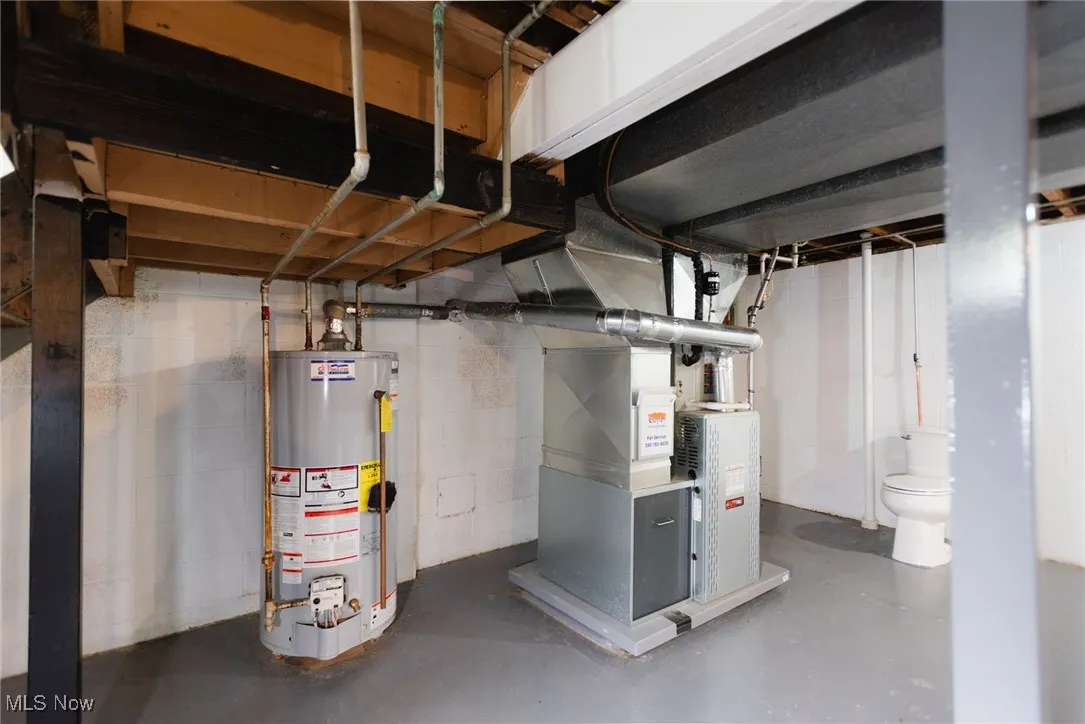 Unfinished below grade area with gas water heater and heating unit