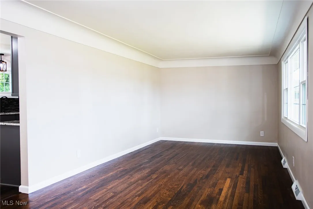 Unfurnished room featuring dark wood-type flooring