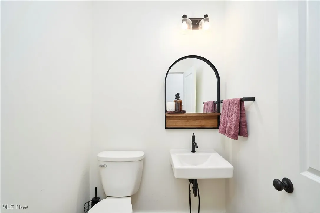 Half bathroom featuring toilet and a sink