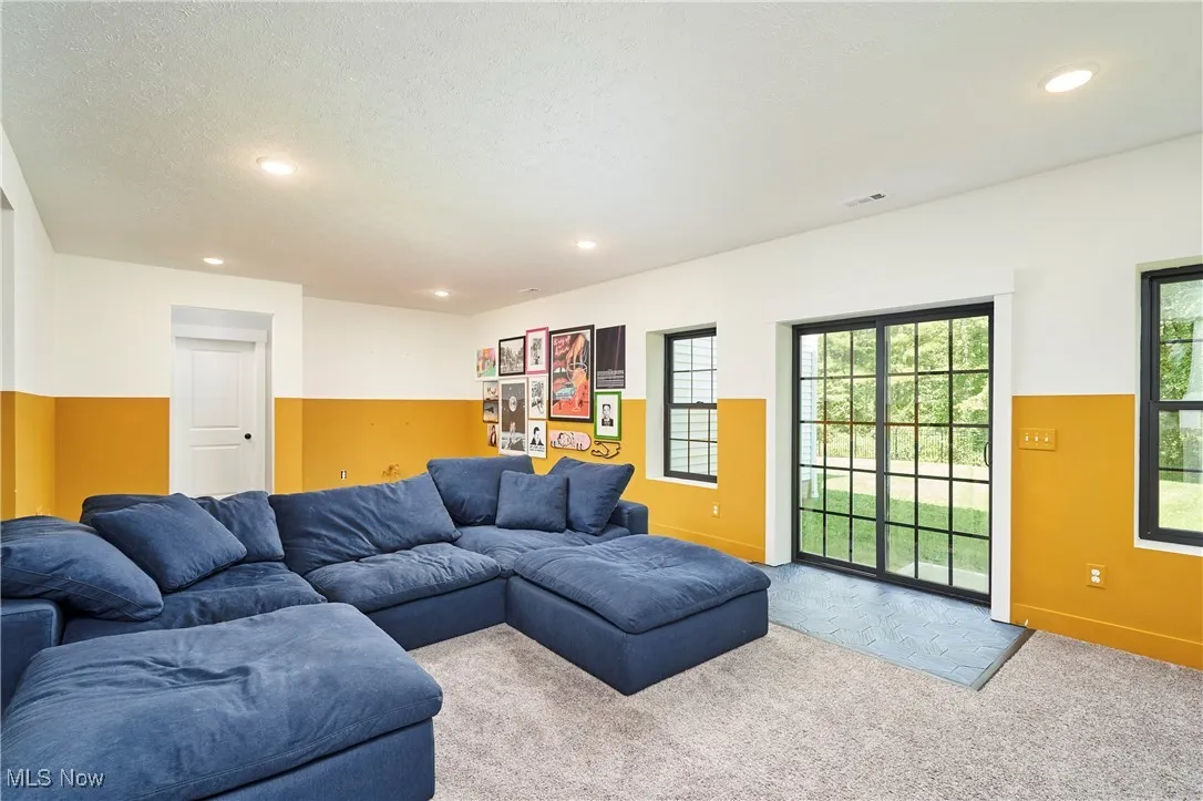 Carpeted living room featuring recessed lighting and baseboards