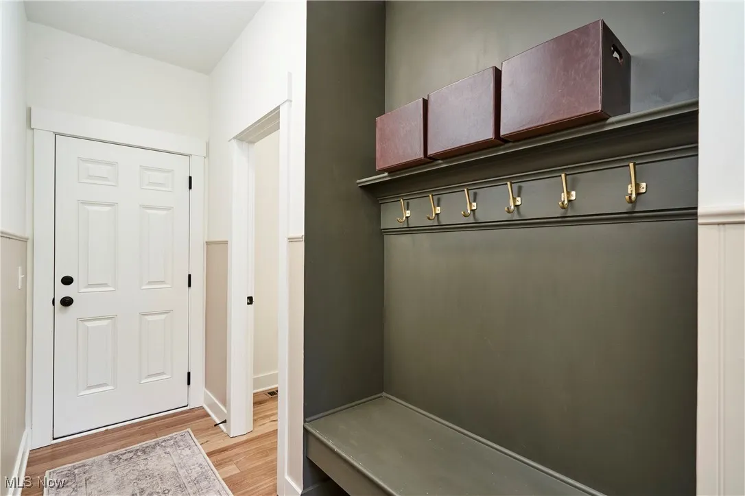 Mudroom featuring light wood-type flooring and baseboards