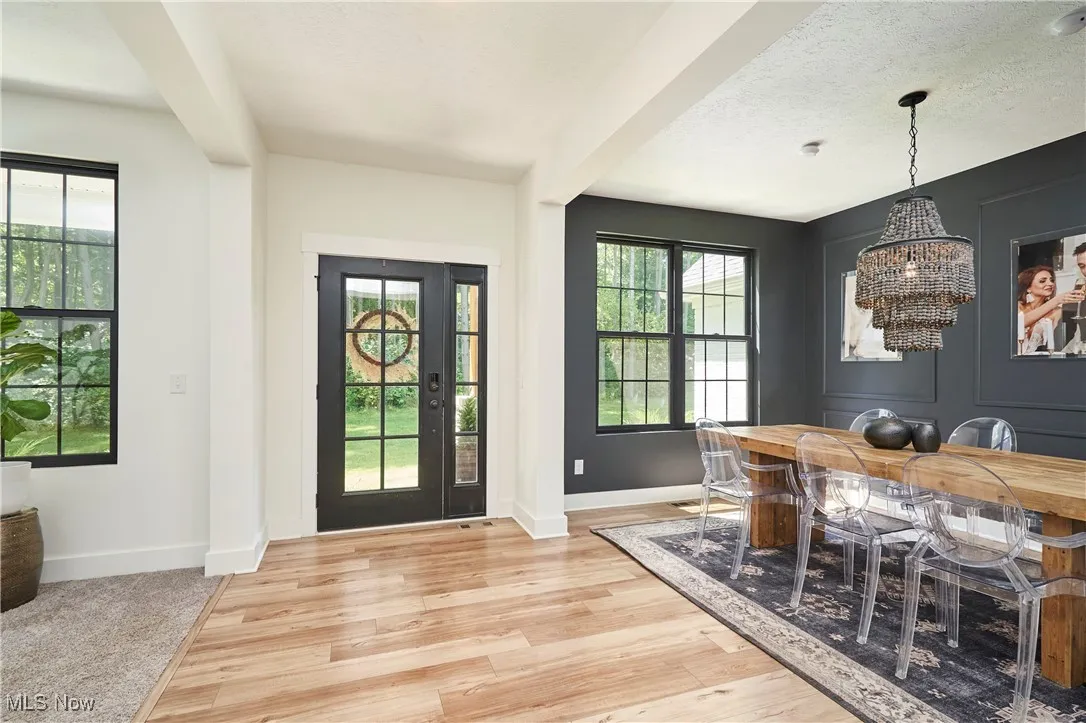 Foyer with a chandelier, light wood finished floors, and a textured ceiling