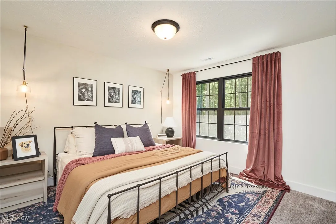 Bedroom with carpet floors and baseboards
