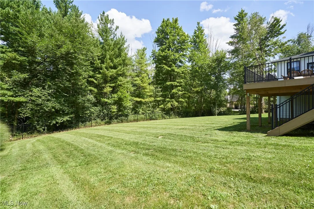 View of yard with a deck and stairs