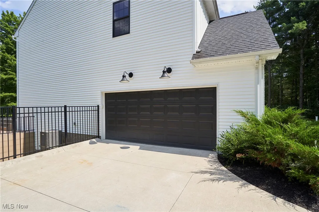 Garage featuring concrete driveway