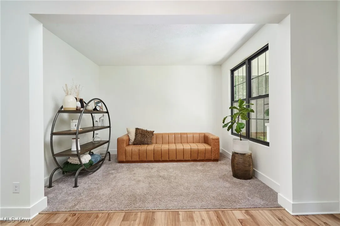Living area featuring light wood-style flooring and baseboards