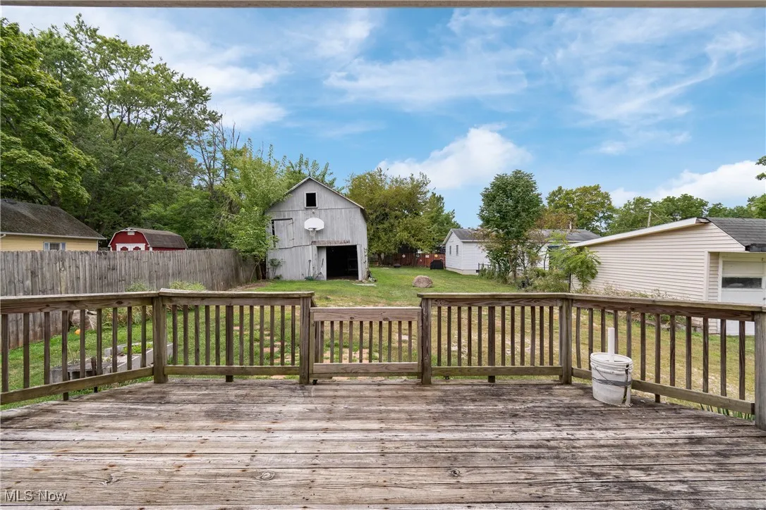 Deck with an outbuilding and a barn