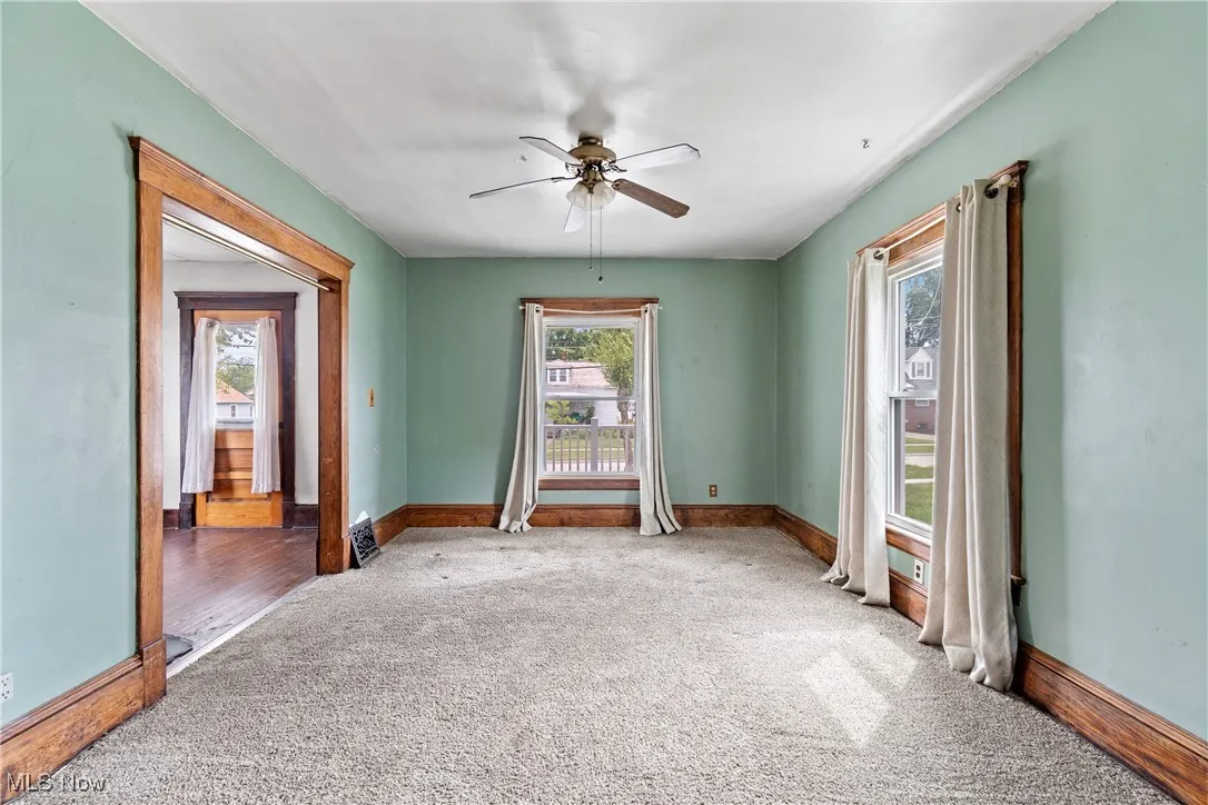 Empty room featuring carpet and a ceiling fan