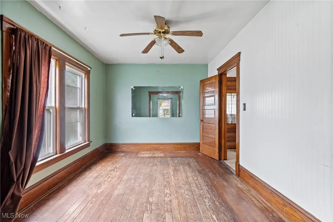 Spare room with wood-type flooring and a ceiling fan