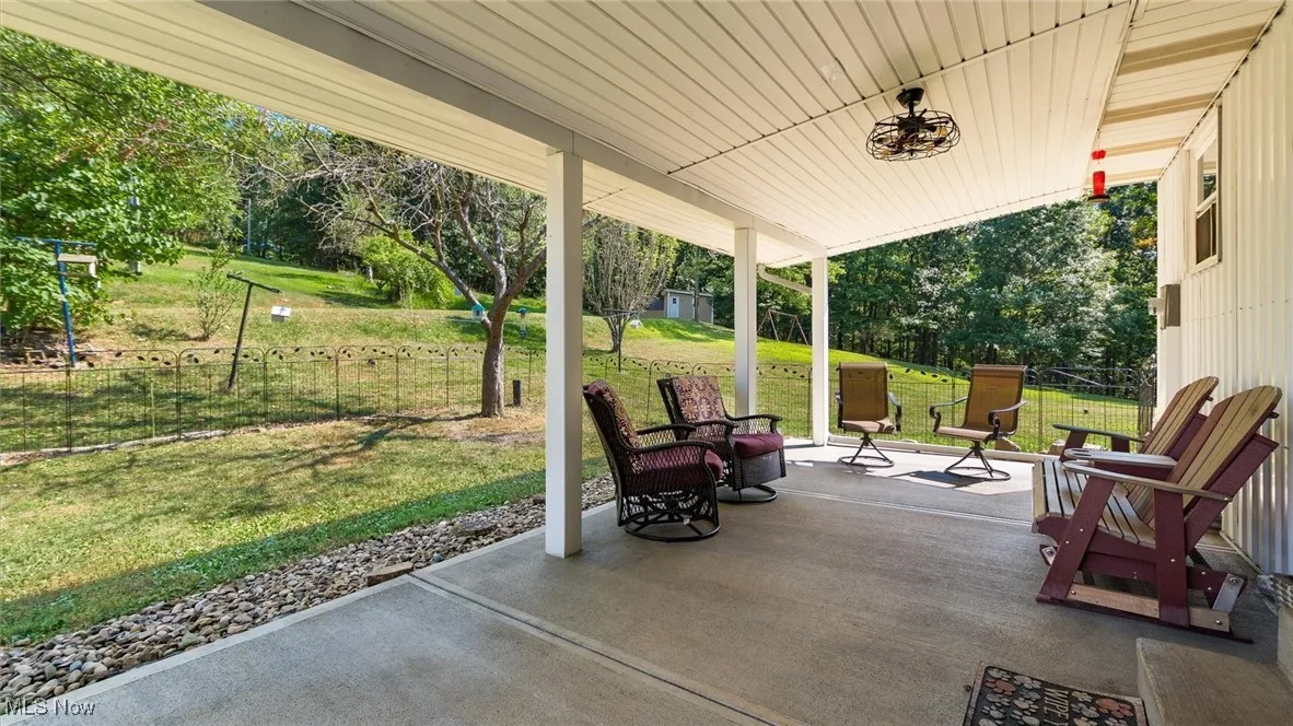 View of patio / terrace with view of wooded area