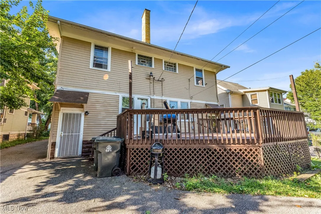 Rear view of property featuring a wooden deck