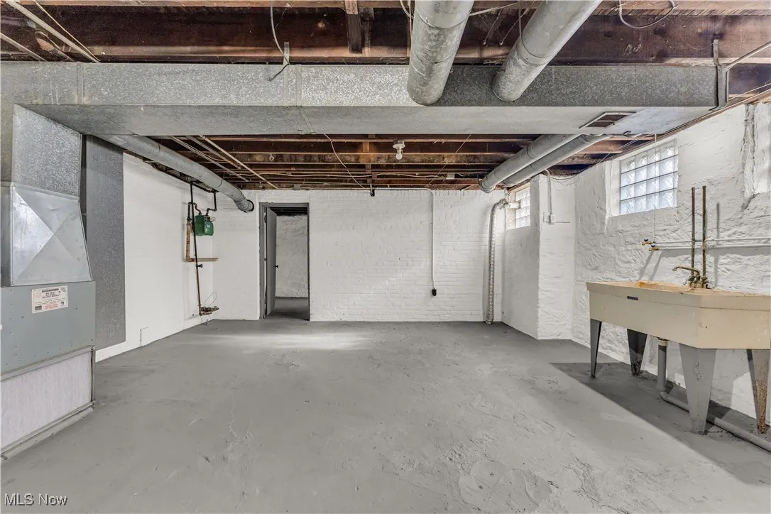 Basement with heating unit and a sink