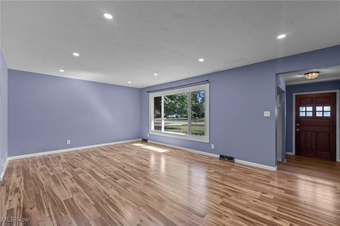 Unfurnished living room featuring recessed lighting and light wood-type flooring