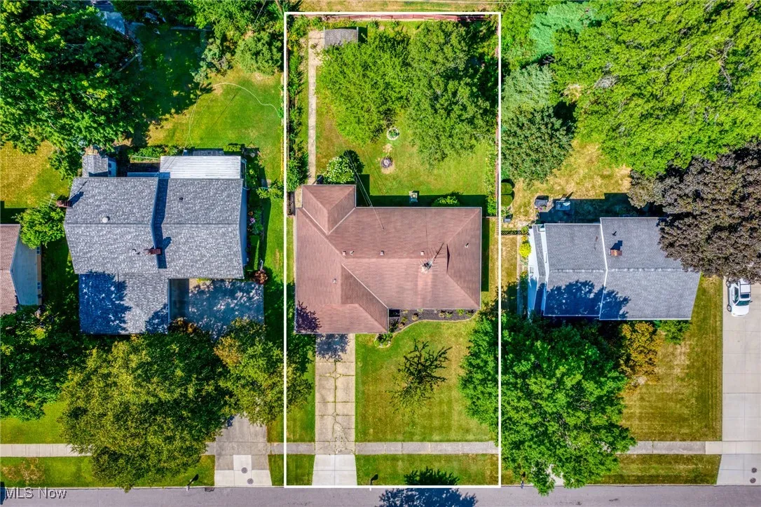 Aerial view of property and surrounding area featuring property parcel outlined