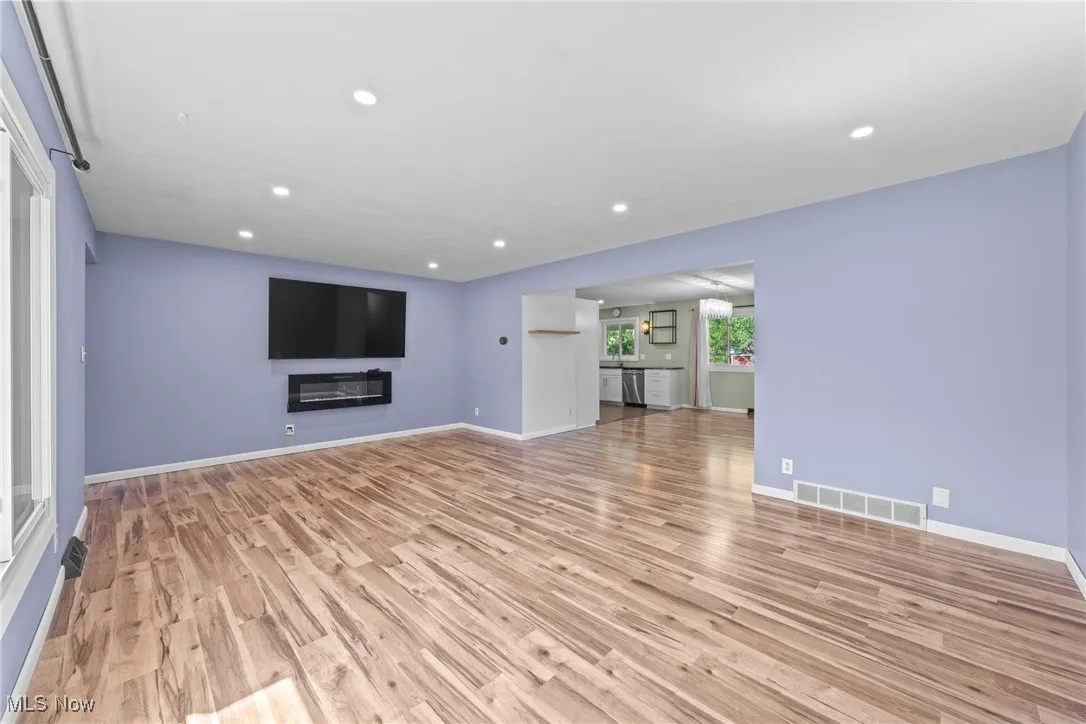 Unfurnished living room featuring light wood-type flooring and recessed lighting