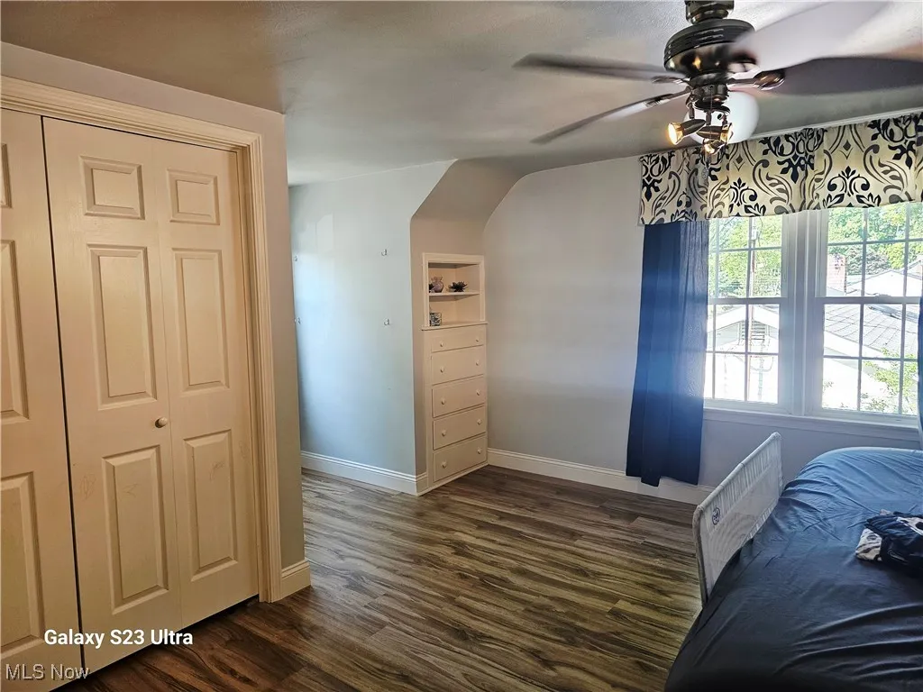 Bedroom featuring dark wood-style floors and ceiling fan
