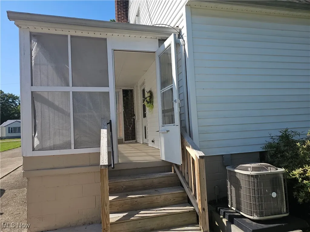 Doorway to property with a sunroom