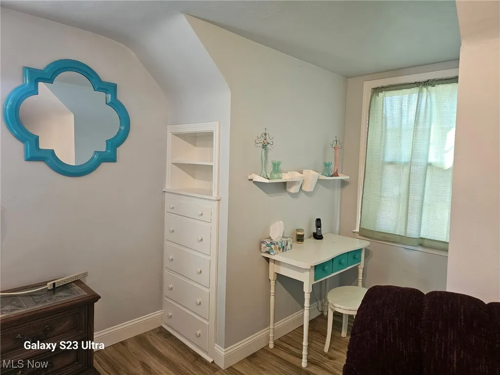 Office area with wood finished floors and baseboards