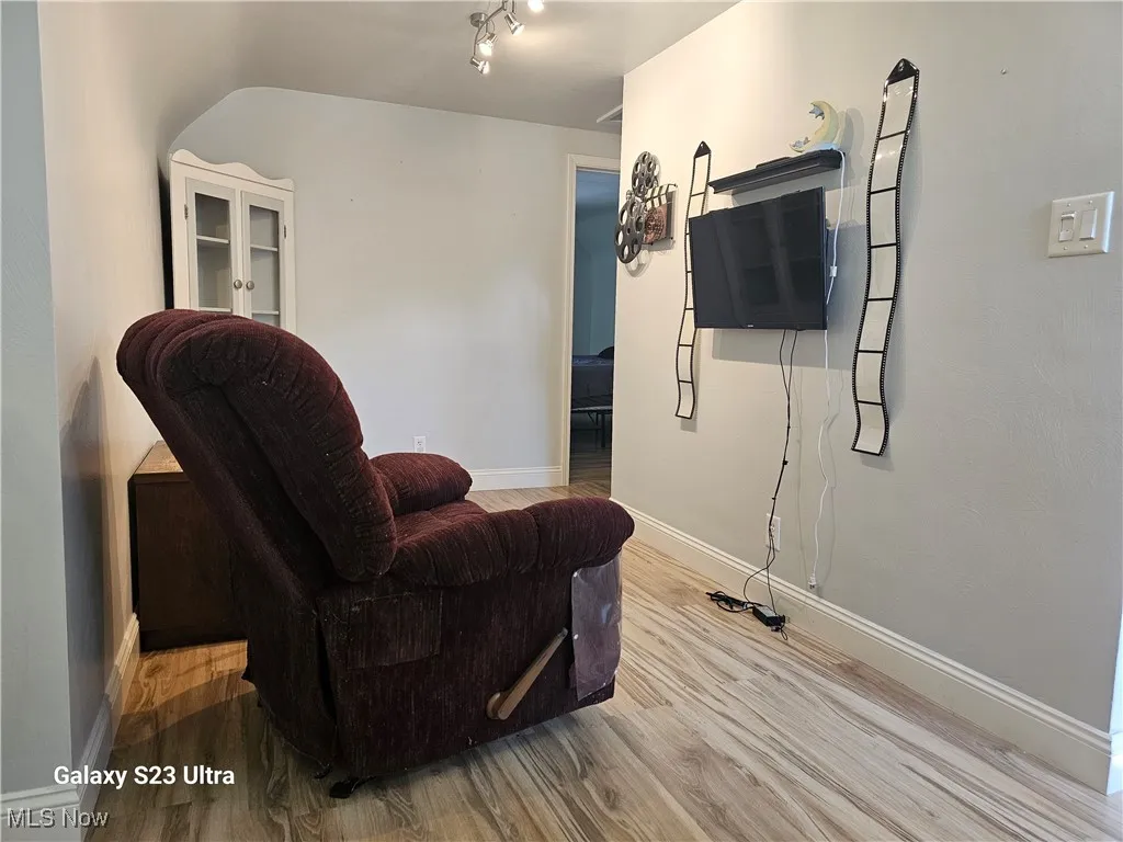 Living area with light wood finished floors and baseboards