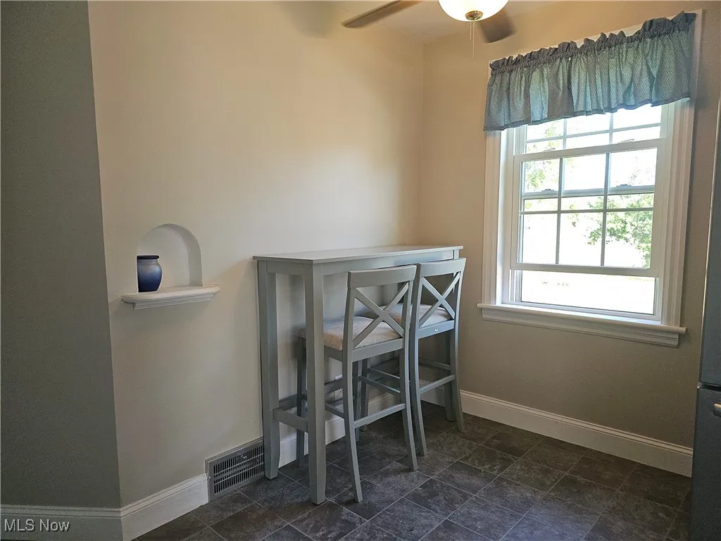 Dining room featuring baseboards and a ceiling fan