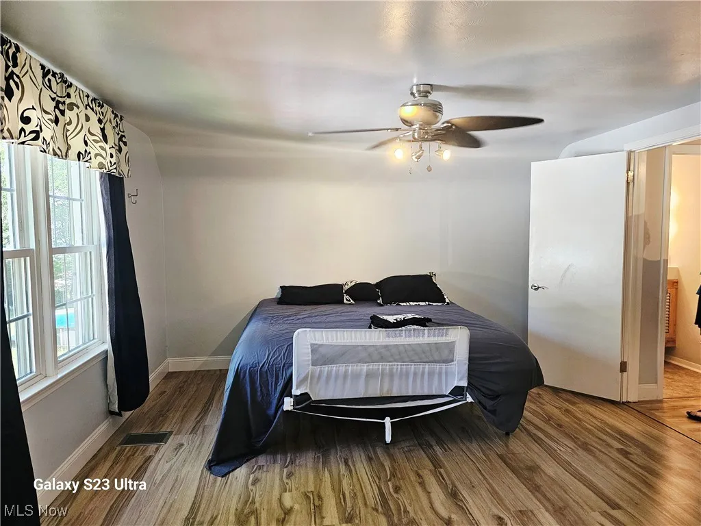 Bedroom with wood finished floors and a ceiling fan