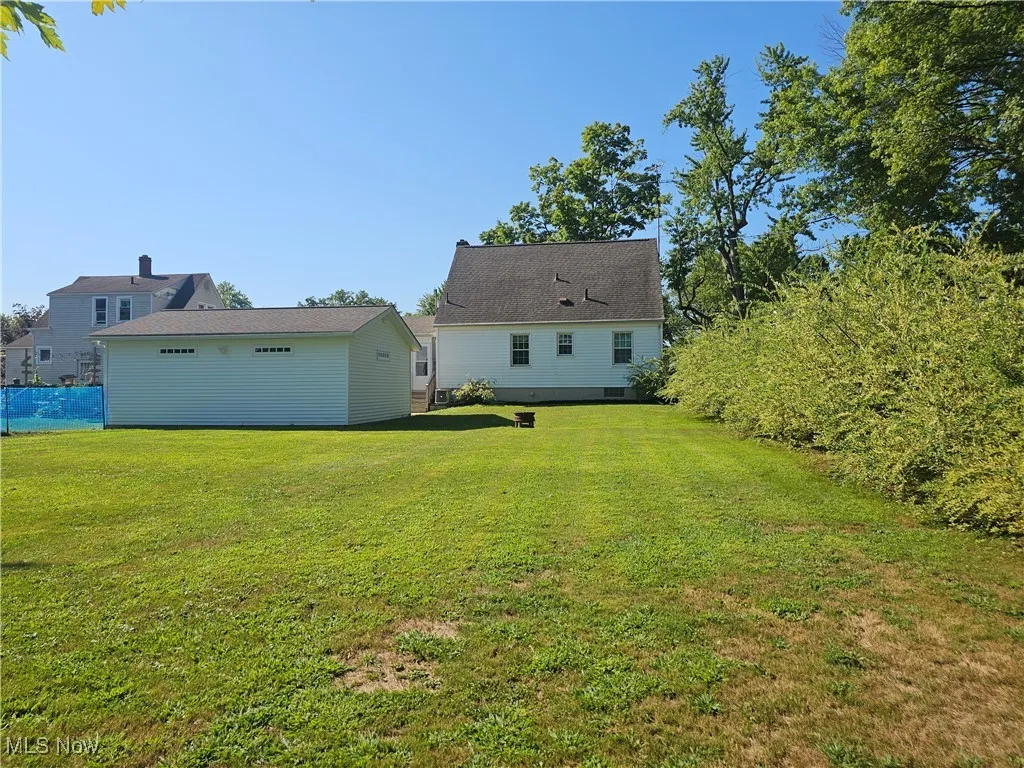 Back of property featuring a yard
