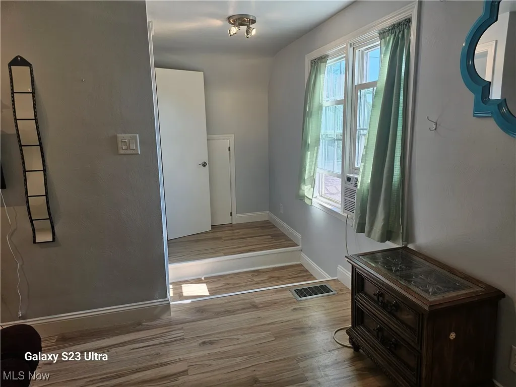 Stairs featuring wood finished floors and baseboards
