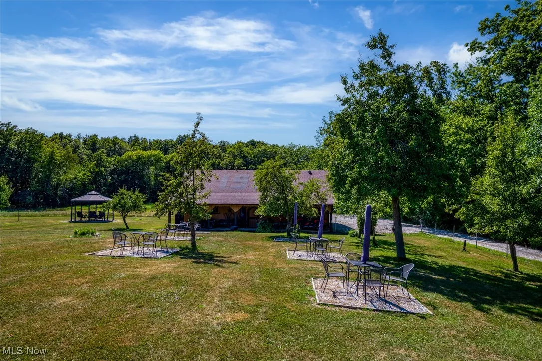 Surrounding community with a gazebo, a patio area, and a lawn